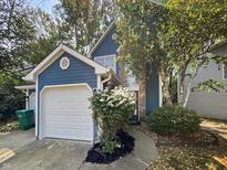 Charming blue two-story home with a white garage door and landscaping at 3213 Oceanline E Dr, Indianapolis, IN 46214