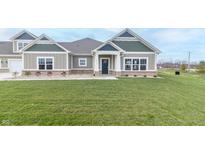 Charming two-story home with a green and white exterior and a lush green lawn at 6210 Fairview Dr, McCordsville, IN 46055