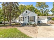 Quaint white house with brick walkway and driveway at 5648 N Keystone Ave, Indianapolis, IN 46220