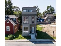 Three-story modern home with gray siding and large windows at 417 E Morris St, Indianapolis, IN 46225