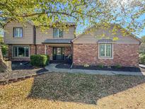 Two story brick and tan house with landscaping at 609 Hickory Ct, Greenfield, IN 46140