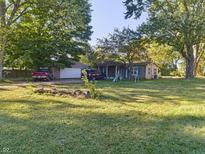 Ranch home with a covered porch, two-car garage, and a large yard at 108 W 650 South, Pendleton, IN 46064