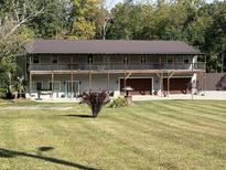 Two-story house with wrap around porch and attached three-car garage at 5724 N Blazing Star Rd, Monrovia, IN 46157