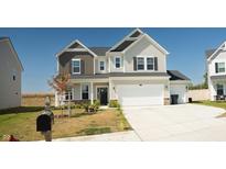 Two-story house with a large driveway and landscaped lawn at 684 Bluestem Cir, Whiteland, IN 46184