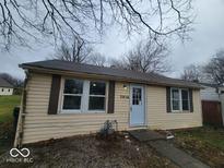 Tan house with new windows and front yard at 3816 St Charles St, Anderson, IN 46013