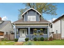 Charming craftsman home with gray exterior, white trim, and a landscaped lawn at 3005 Broadway St, Indianapolis, IN 46205