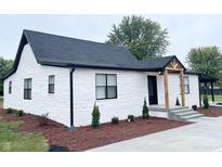 Modern farmhouse exterior with white brick and black roof at 2068 S Avon Ave, Avon, IN 46123
