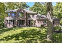 Brick two story home with a large front yard and mature trees at 5826 Winding Way Ln, Indianapolis, IN 46220