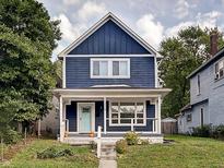 Charming two-story navy blue house with white trim at 1229 N Keystone Ave, Indianapolis, IN 46201