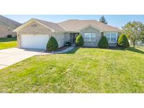 Brick ranch home with attached garage and landscaped lawn at 884 N Shore Blvd, Franklin, IN 46131