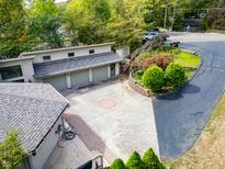 Large driveway leading to a three-car garage at 4161 S Summit Ln, Columbus, IN 47201