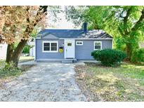 Newly renovated gray house with a front yard and driveway at 2035 N Tibbs Ave, Indianapolis, IN 46222