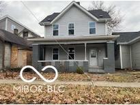 Two story home with gray siding and front porch at 814 S State Ave, Indianapolis, IN 46203
