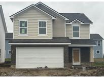 Two-story home with beige vinyl siding, white garage door, and dark roof at 11011 Walter Dr, Indianapolis, IN 46235