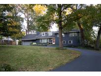 Ranch home with dark blue exterior and landscaping at 6205 Bramshaw Rd, Indianapolis, IN 46220