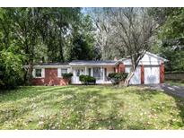 Brick ranch house with attached garage and mature landscaping at 3226 W 46Th St, Indianapolis, IN 46228