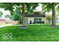 Ranch style home with gray siding, and a spacious lawn at 4839 Alameda Rd, Indianapolis, IN 46228