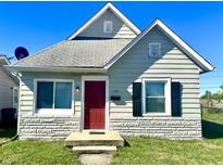 Charming bungalow with a red door and stone accents at 1750 Linden St, Indianapolis, IN 46203