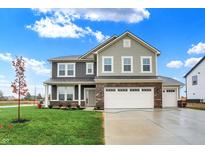 Two-story house with gray siding, brick accents, and a three-car garage at 7193 Portico Ln, McCordsville, IN 46055