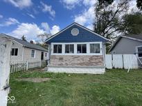 Brick ranch home with blue siding and landscaping at 1925 N Oxford St, Indianapolis, IN 46218