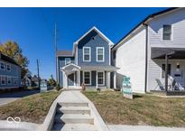 Two-story blue home with a front porch and landscaped yard at 1666 Union St, Indianapolis, IN 46225
