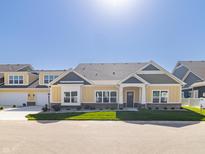 Craftsman style home with gray and yellow siding, two-car garage, and landscaped yard at 4435 W Preserve Pass, New Palestine, IN 46163