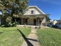 Quaint house with a porch and well-maintained lawn at 2502 W 10Th St, Indianapolis, IN 46222