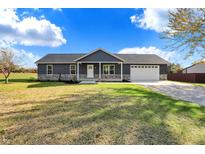 Modern ranch home with stone accents and a two-car garage at 7234 N Christopher Ln, Fairland, IN 46126