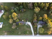 Aerial view showcasing a house and surrounding landscape with fall foliage at 3231 W State Road 32, Westfield, IN 46074