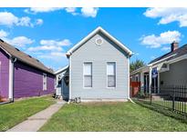 Charming light blue house with a well-maintained lawn at 1120 Lexington Ave, Indianapolis, IN 46203