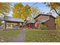 Two story home with covered porch and autumn landscaping at 9562 N Gasburg Rd, Mooresville, IN 46158