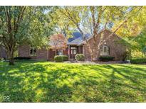 Brick ranch home with mature trees and landscaping at 1079 Old Eagle Way, Greenwood, IN 46143