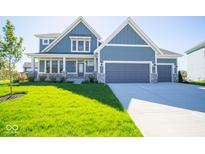 Two-story house with blue siding, stone accents, and a two-car garage at 53 Hampstead Ct, Westfield, IN 46074