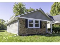 Charming gray exterior with brick accents and well-manicured lawn at 2532 N Gale St, Indianapolis, IN 46218