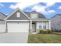Gray two-story home with white garage doors and landscaping at 802 Weldon Way, Westfield, IN 46074