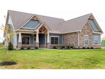 Two-story craftsman home with stone and blue siding at 4407 W Wandalee Ct, New Palestine, IN 46163