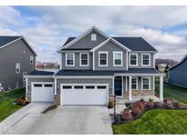 Two-story house, gray siding, white garage doors, landscaped yard at 16703 Ayshire Dr, Fishers, IN 46037