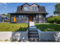 Charming two-story home with dark exterior and lawn at 2641 Guilford Ave, Indianapolis, IN 46205