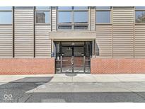 Modern building entrance with glass doors and brick base at 1521 N Alabama St # L, Indianapolis, IN 46202