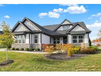 Craftsman style home with gray and white exterior, stone accents, and landscaping at 12594 Tidecrest Dr, Fishers, IN 46037