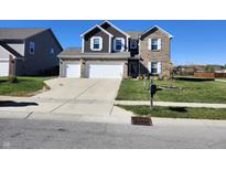 Two-story house with three-car garage and landscaping at 428 N Wyndstone Way, Fortville, IN 46040