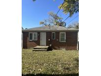 Brick home with a white door and a spacious backyard at 4529 Crittenden Ave, Indianapolis, IN 46205