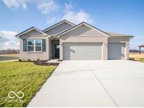 Brick house with three-car garage and landscaped lawn at 2298 Pine Valley Dr, Plainfield, IN 46168