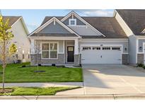 Gray siding two-car garage craftsman style home with stone accents at 10549 Maidenhair Dr, Indianapolis, IN 46239