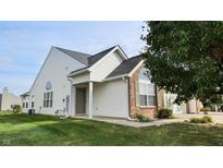 Brick and white side exterior of charming ranch home with landscaped yard at 1202 Creek Bend Dr, Greenwood, IN 46143