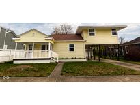 Cute yellow house with a unique carport and a small front yard at 211 Taylor St, Mooresville, IN 46158