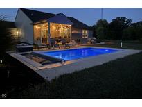 Inviting inground pool with a covered patio and string lights at 3503 W 100 N, Bargersville, IN 46106