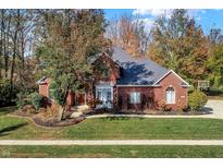 Brick house with a large yard and basketball hoop at 6640 Greenridge Dr, Indianapolis, IN 46278