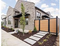 Modern brick home with a walkway and fenced yard at 1679 Ties Way, Westfield, IN 46074