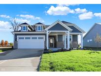 Two-story house with gray siding and stone accents at 7171 Rose Hill Ave, Brownsburg, IN 46112
